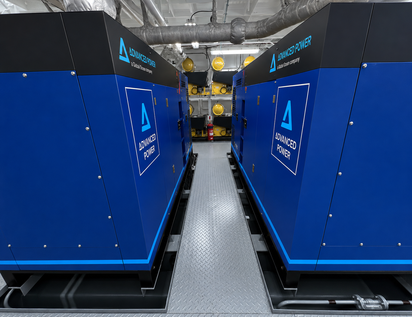Two blue Advanced Power generating sets installed facing each other in a vessel engine room
